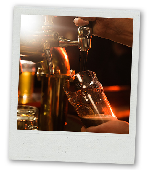 A Polaroid of a bartender pulling a pint