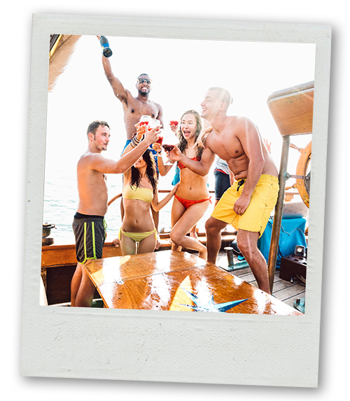 A Polaroid of a mixed gender group of people enjoying some drinks on a boat