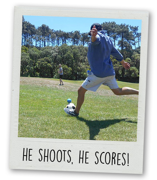 A Polaroid of a man about to kick a football with the caption he shoots he scores