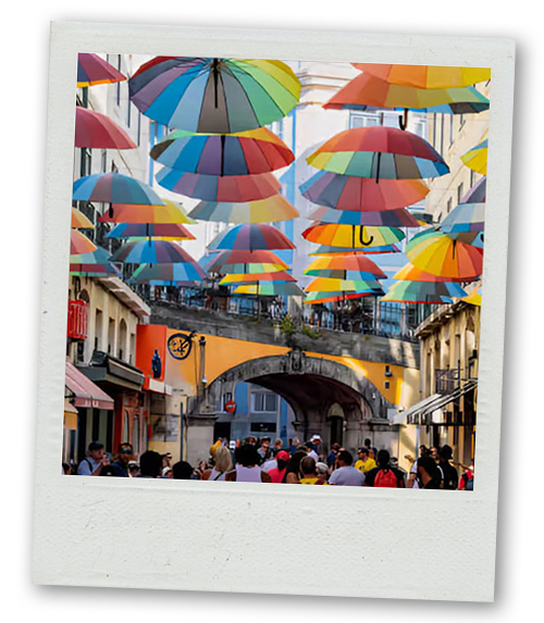A Polaroid of the many rainbow coloured umbrellas that hang over Pink Street