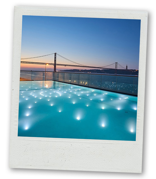A Polaroid of rooftop pool overlooking a bridge at sunset