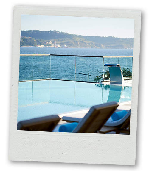 A Polaroid of some sunloungers next to an infinity pool