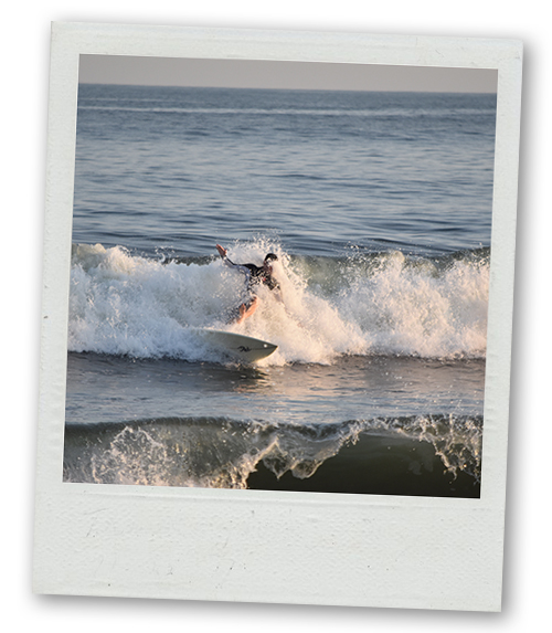 A Polaroid of someone surfing a big wave