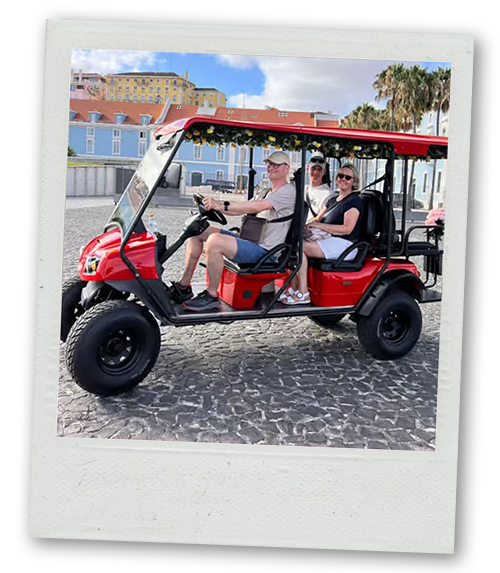 A Polaroid of some people riding a red Tuk Tuk