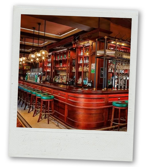 A Polaroid of an old fashioned looking wooden bar in the Cathedral Quarter