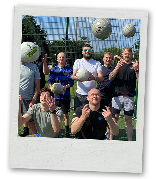 A Polaroid of a stag do group throwing their balls in the air