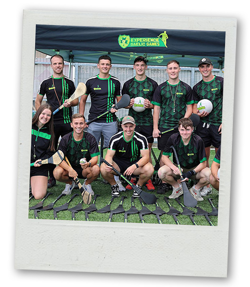 A Polaroid of a stag do group posing for a pic with hurling gear