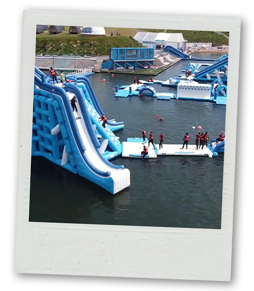 A Polaroid of an inflatable course that is over water 
