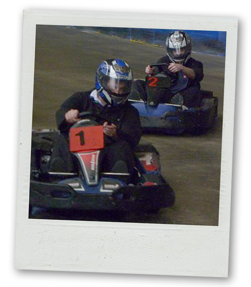 A Polaroid of two men go karting