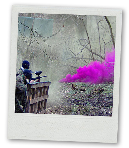 A Polaroid of some men paintballing in the woods