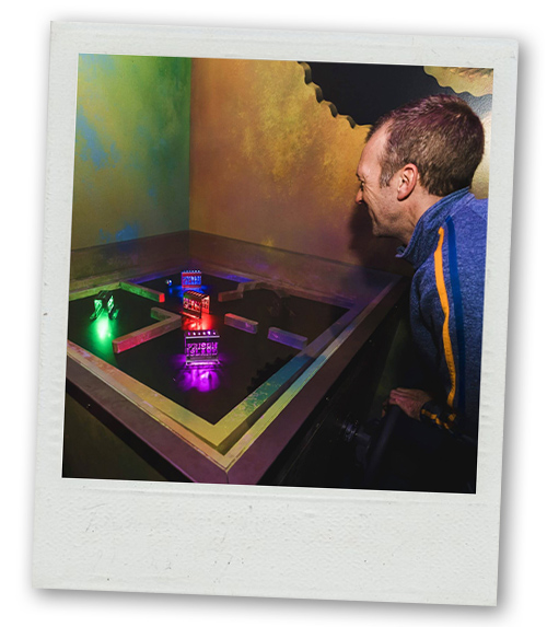 A Polaroid of a man trying to solve a puzzle at Prison Island