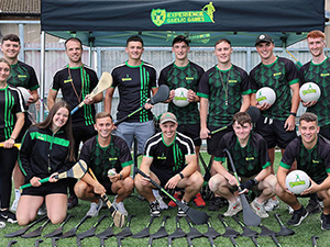 A stag do group posing with curling gear about to play some Gaelic themed games 