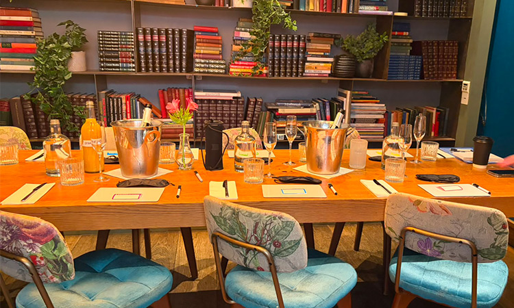 A table set up to play Backstabbers Village with whiteboards and bucks fizz