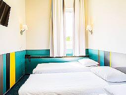 A colourful twin guest room at Ecotel Vilnius