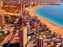 Aerial view of Benidorm sea front with hotels and beach in image