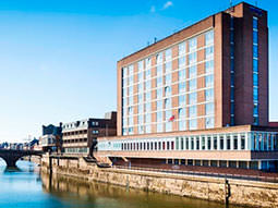 The exterior of the hotel on the river banks, under a lovely blue sky