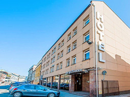 The exterior of Hotel Alexander with flags flying outside