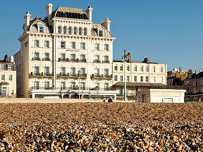 Exterior of the Mercure Brighton Seafront Hotel, and beach, during the day