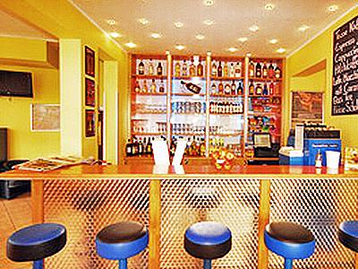 The bar area of A&O Hackerbruke, with blue bar stools 