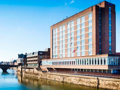 The exterior of the hotel on the river banks, under a lovely blue sky - Rank #2
