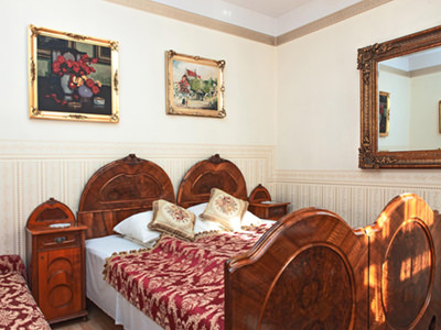 A double bed in a grand, old fashioned room
