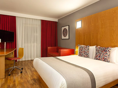 A double bed in a room at Ramada Encore Belfast