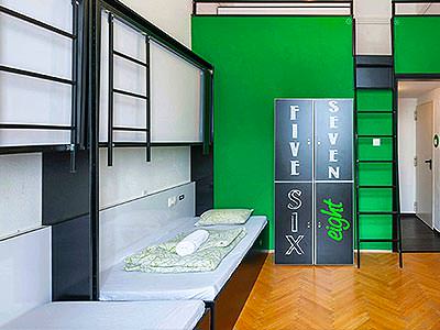 A room with dark green walls, beds and lockers with numbers written on - Rank #9