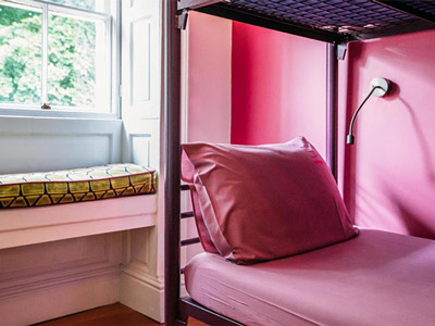 A close up of a pink pillow on the bottom bed of a bunkbed at Safestay York