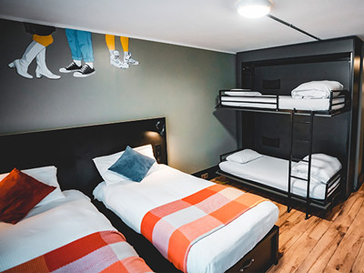 Two single beds side by side with a set of bunkbeds to the right of them at Generator Dublin