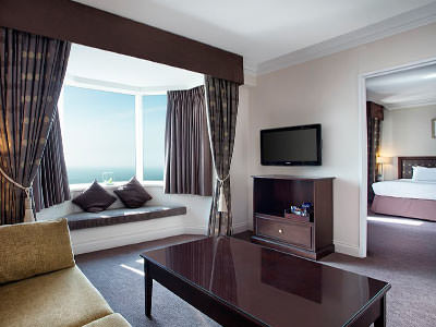 Sofa, coffee table and TV in a hotel suite