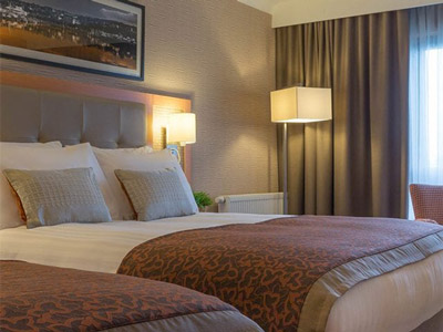 A double room with warm lighting at Clayton Hotel Leeds