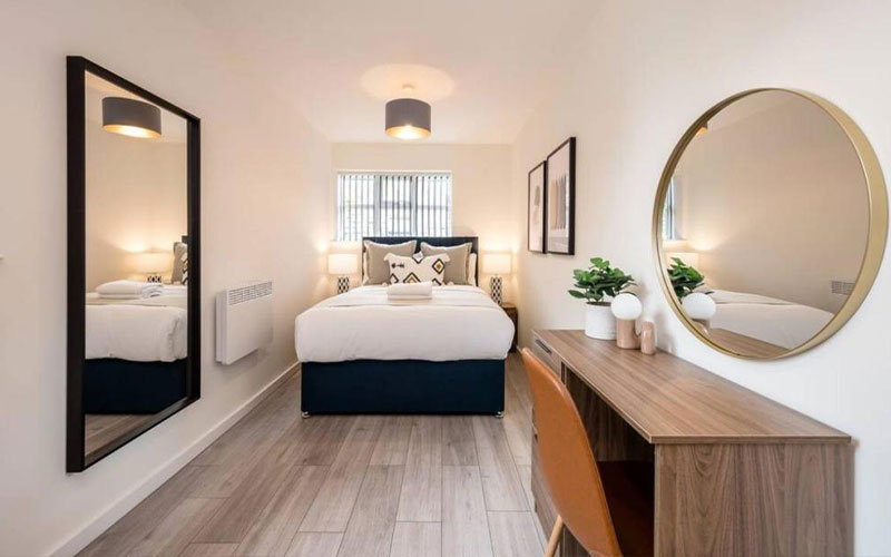 A stylish bedroom with full length mirror 