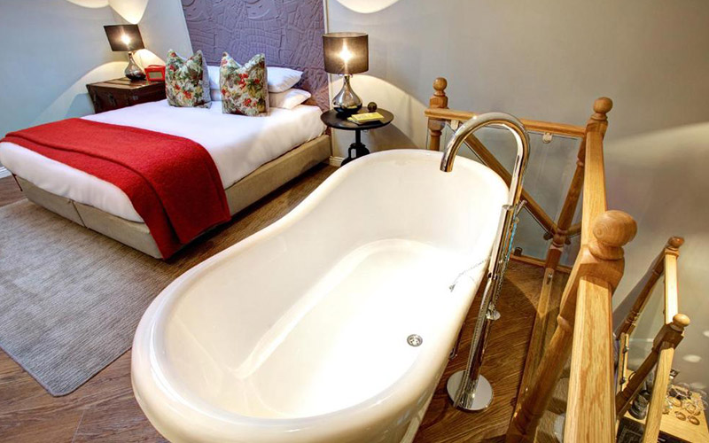 An apartment bedroom with a freestanding bath 