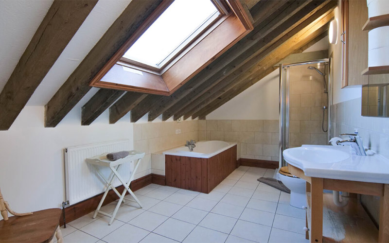 Bathroom two featuring a bath and a shower 