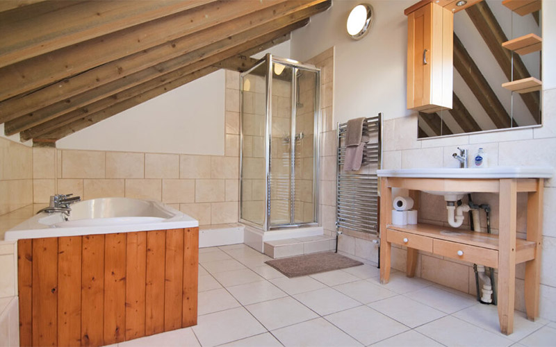 Bathroom two with a bath and shower 