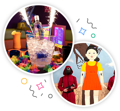 A bottle of vodka inside an ice bucket which has sparklers inside and is placed on a table decorated with bright party accessories and The schoolgirl from ‘Red Light, Green Light’ is painted on a wall, with two masked, gun-wielding Squid Games guards alongside her.