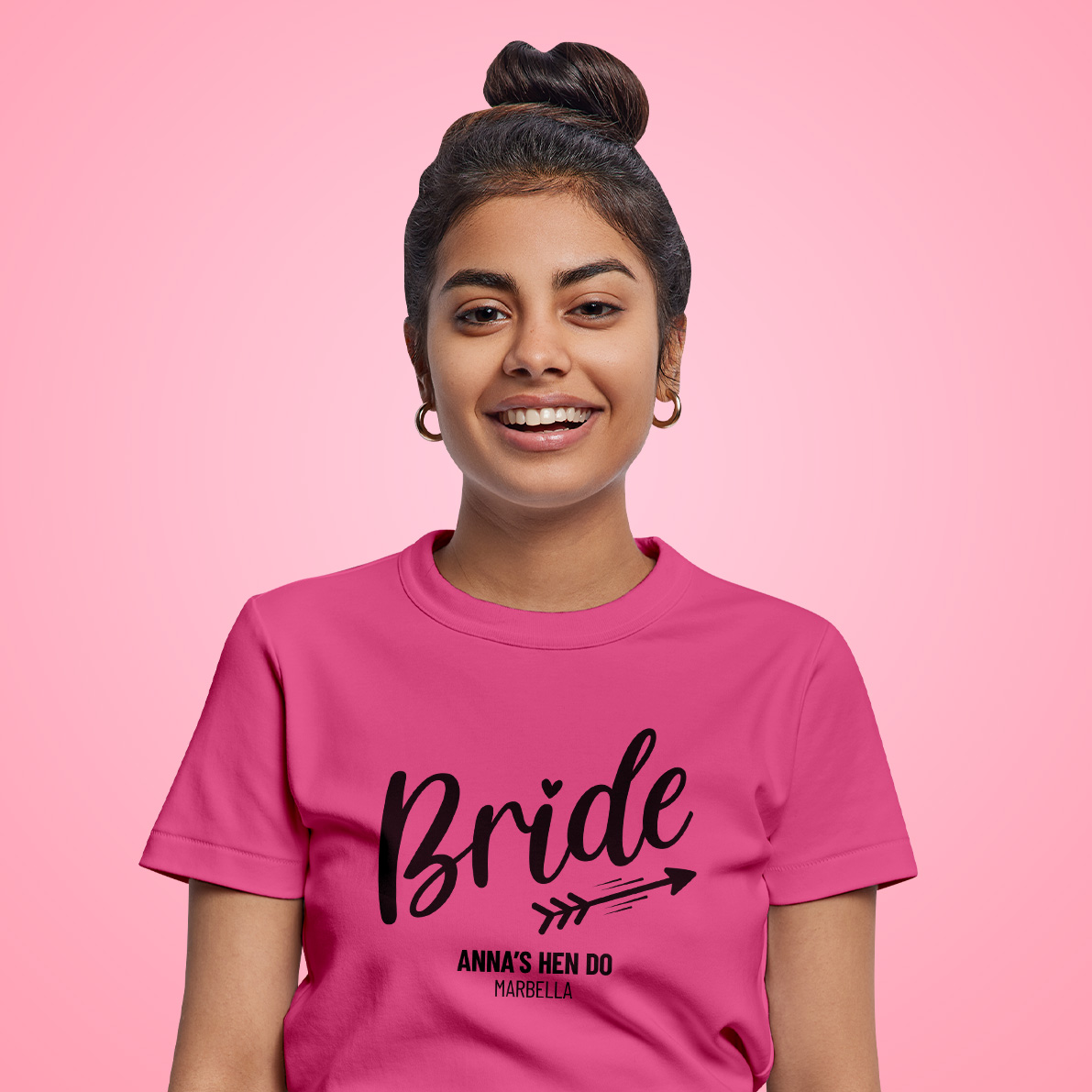 Woman wearing a pink T-shirt that reads Bride, Anna’s Hen Do, Marbella