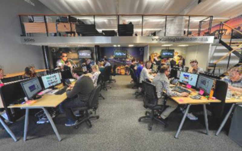 A photo of the inside of our Gateshead office, with staff working at their computers