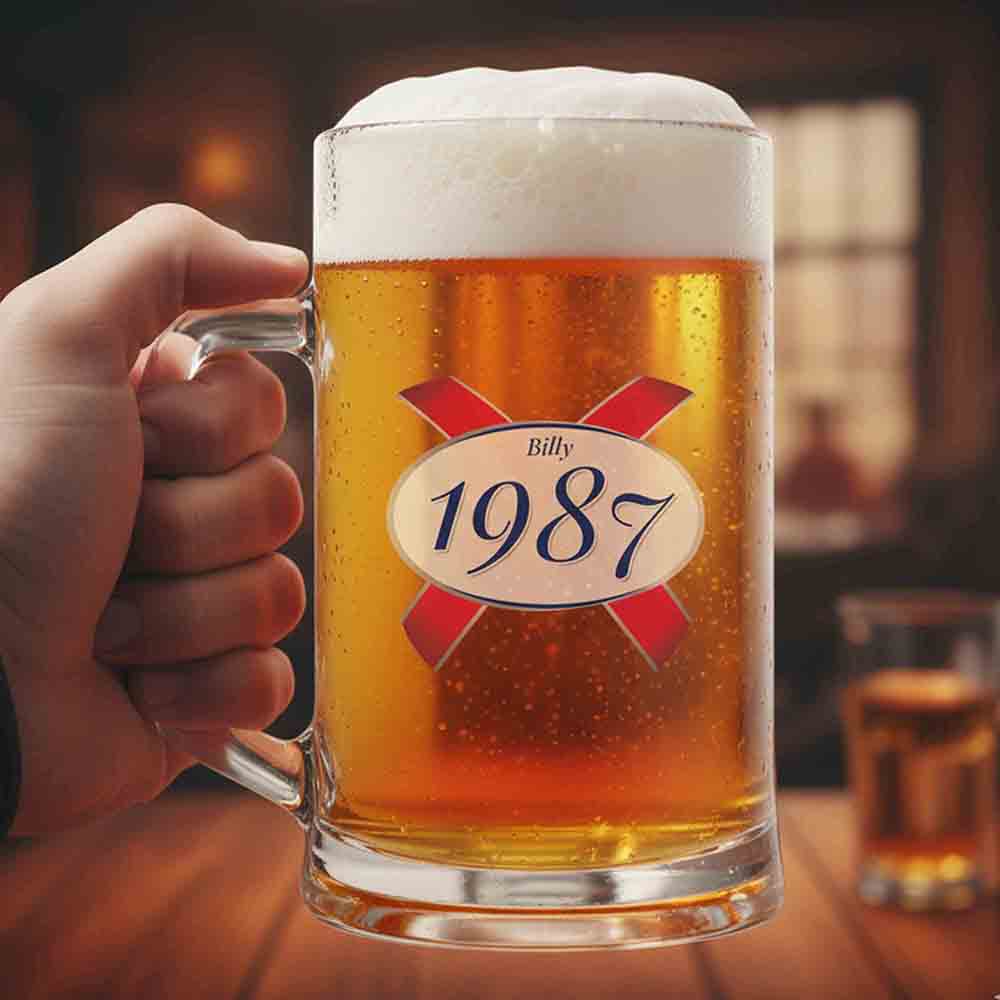 A custom Kronenbourg-inspired birthday stein with frosted glass that reads Billy 1987 with a pub background