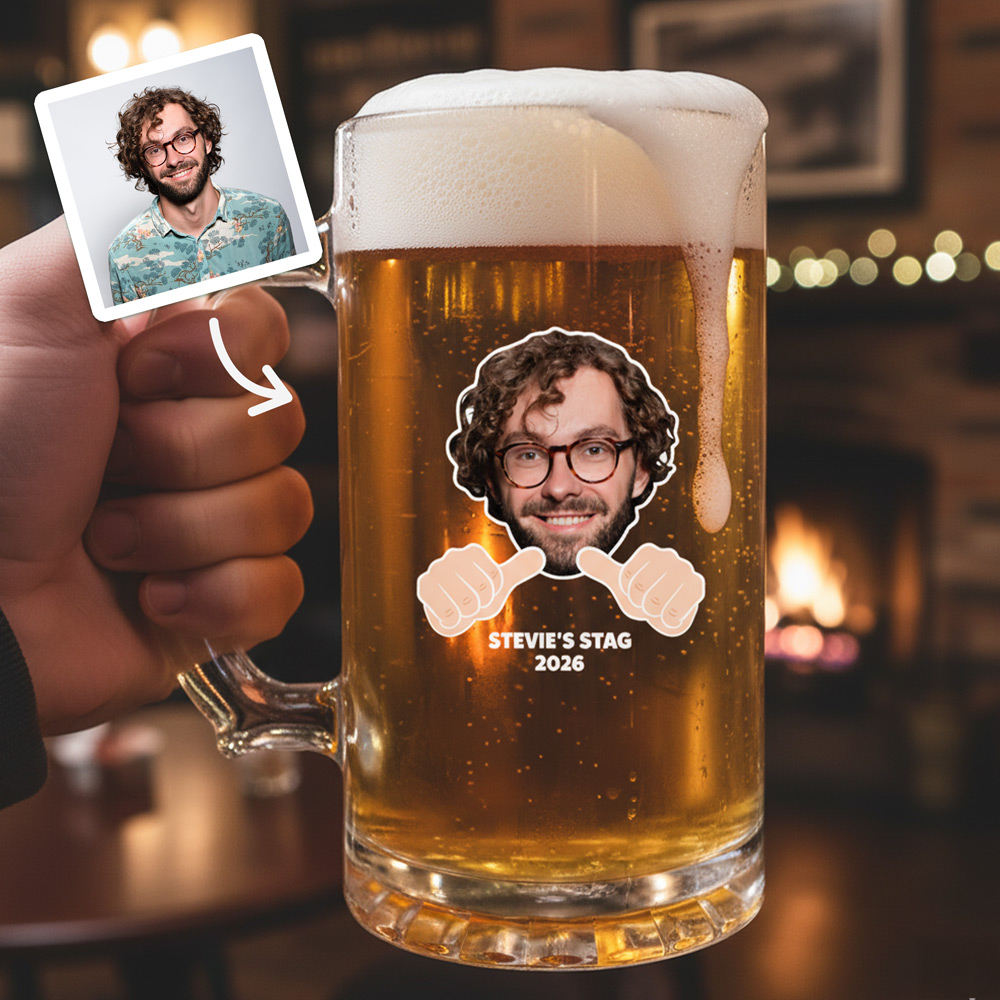 A custom stein that has been personalised with a man's face that have cartoon thumbs pointing towards him and custom text reading Stevie's Stag 2026 with a pub background