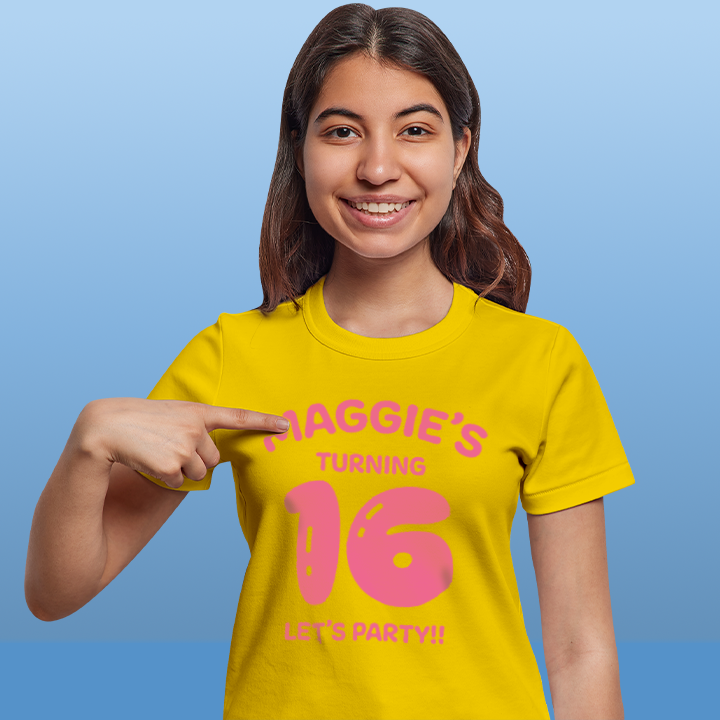A female model wearing a custom 16th birthday shirt with 16 in a balloon font and space for the birthday person's name and an additional line of text 