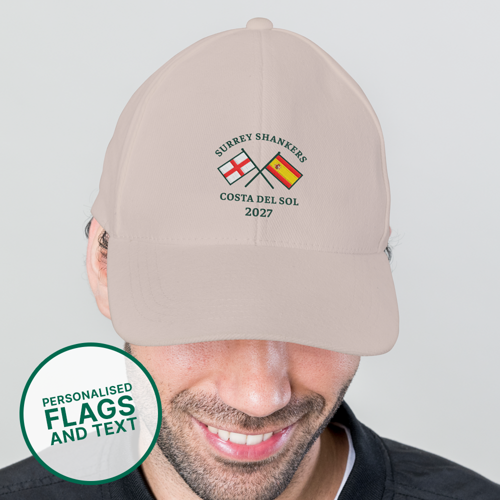 A male model wearing a custom golf cap with a multi flags design that is an England flag crossed over a Spain flag with the custom text Surrey Shankers, Costa Del Sol, 2027 