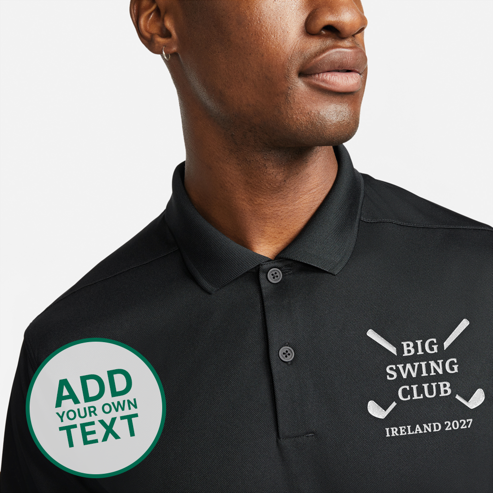 A male model wearing a black golfing shirt with an embroidered logo reading Big Swing Club with a design of two golf clubs crossed over each other in an X shape behind the words 