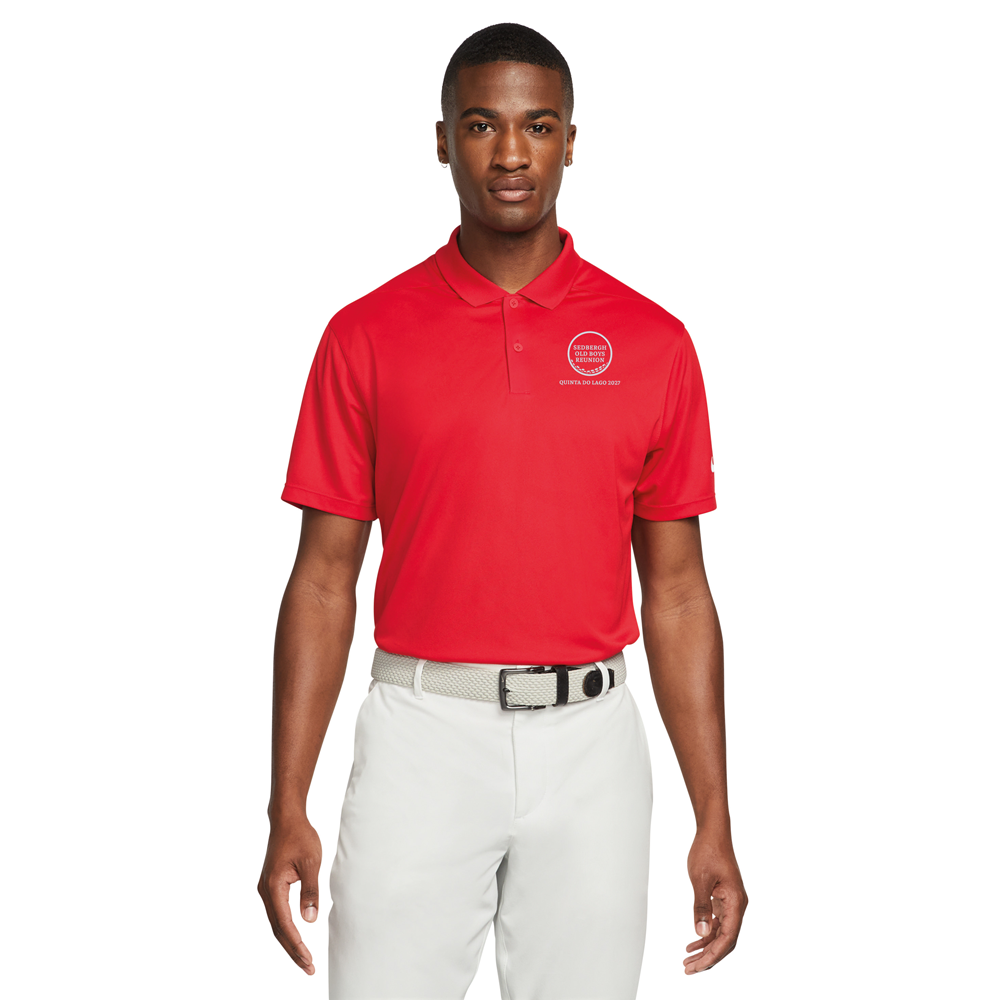 A male model wearing a red custom golf polo with a golf ball design that reads Sedbergh Old Boys Reunion inside the golf ball with Quinta Do Lago 2027 underneath it