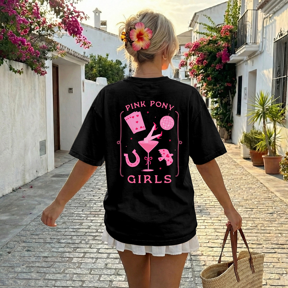 The back of a black Pink Pony club hen do t shirt that has a design in dark pink including cards, a disco ball and a horseshoe with the text Pink Pony Girls