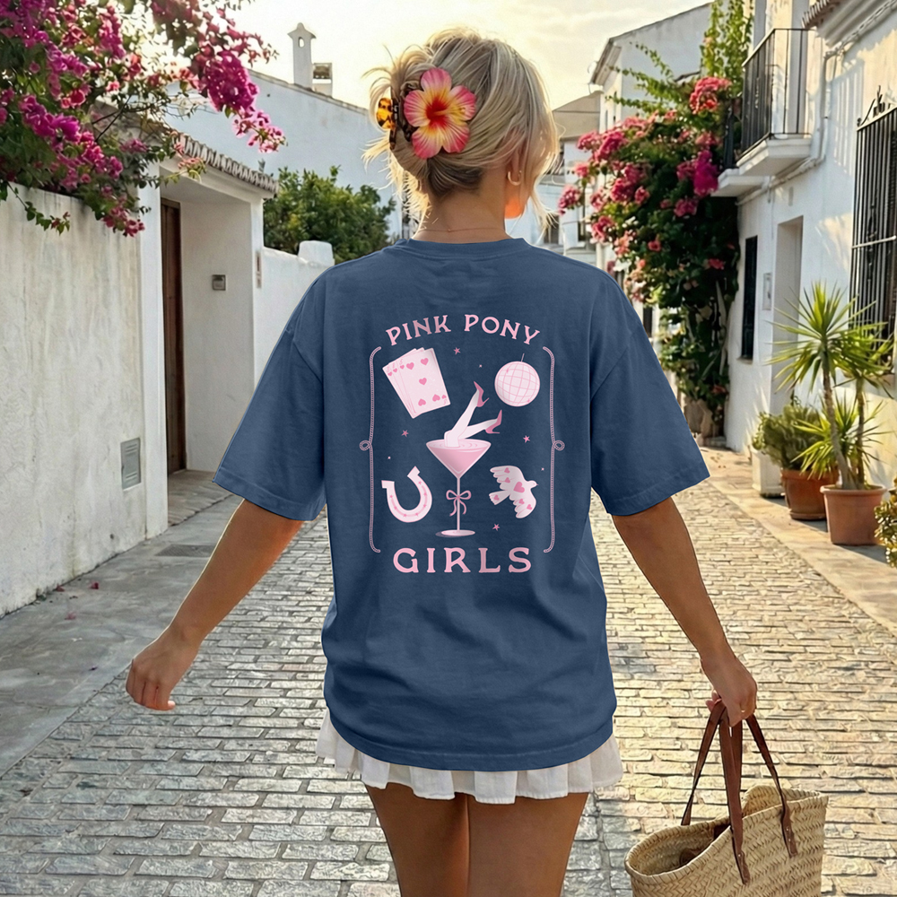 The back of a blue Pink Pony club hen do t shirt that has a design in light pink including cards, a disco ball and a horseshoe with the text Pink Pony Girls