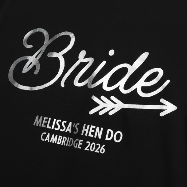 A black hen do shirt with custom shiny white foil text that reads Bride, Melissa's Hen Do, Cambridge 2026