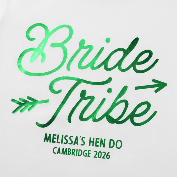 A white hen do shirt with custom shiny foil green coloured text that reads Bride Tribe, Melissa's Hen Do, Cambridge 2026