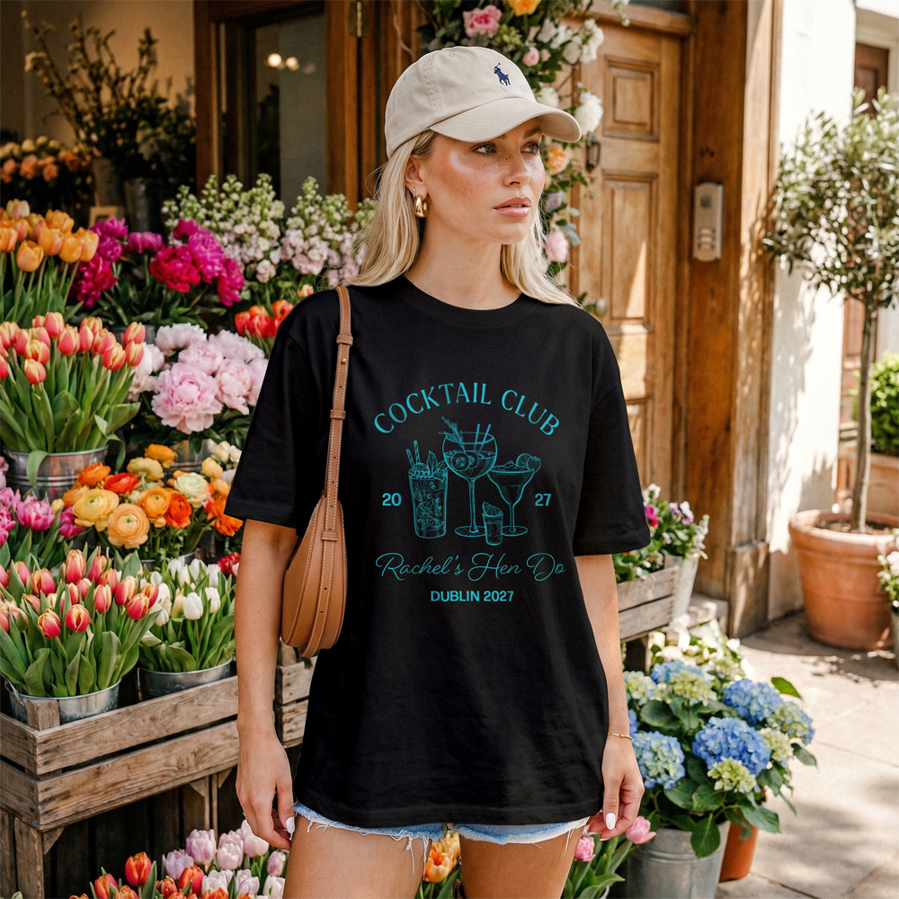 A burgundy t-shirt with a pink design that has a cowboy boot on it and two cactus that reads yee-haw it's time for Megan's last rodeo. 