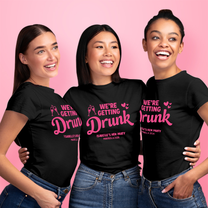 Three women wearing black custom hen do t shirts with editable text that reads We're getting drunk, Isabelle's Hen Party, Marbella 2026